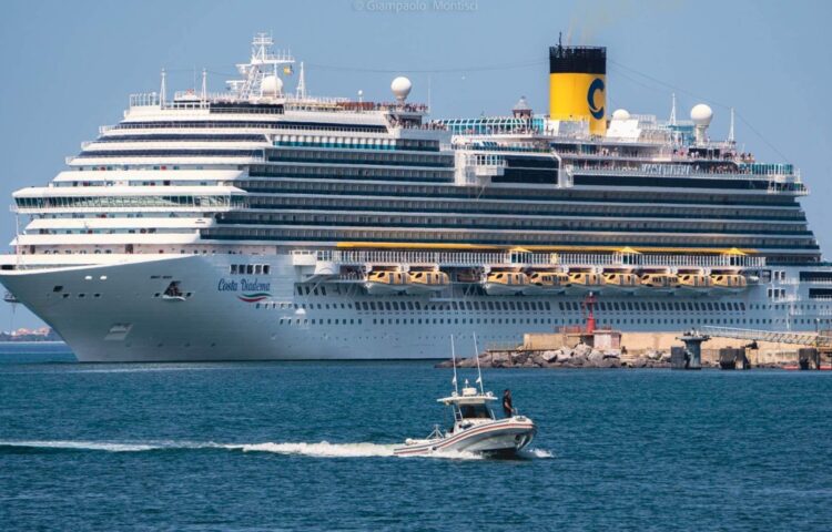 Costa Diadema cruise ship entering the Port of Oristano with Hurakan Cab Dorado 10 workboat in operation